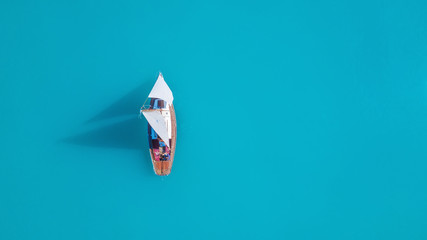 Yacht on the water surface from top view. Turquoise water background from top view. Summer seascape...