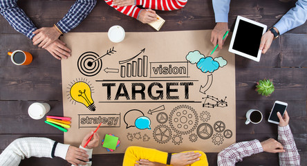 Group of business people looking at strategy sketch