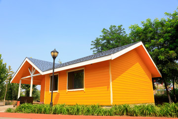 Fototapeta na wymiar Yellow wooden house in the park