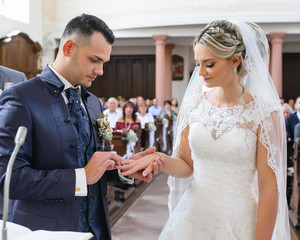  Groom putting ring on bride's finger