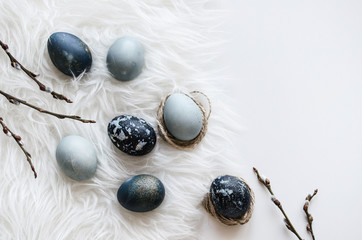 Delicate composition for the holiday of Easter. Painted eggs in blue tones. Background for the presentation of work or text. Top view. Copy space.  Mock-up