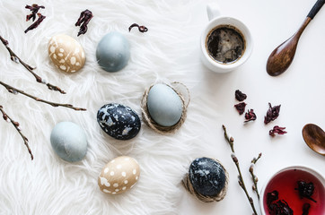  The concept of coloring eggs in hibiscus and coffee. Eco dyes..Background to the day of Easter. Top view. Copy space.  Mock-up