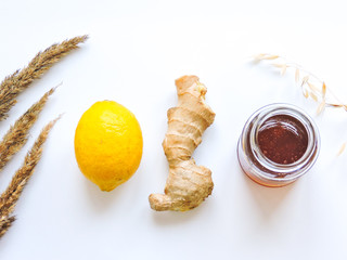 Naklejka na ściany i meble Lemons and ginger on a white background.Healthy food. Ginger Root Tea with Lemon. Healthy ingredients against cold.Top view image of lemon and ginger with copy space. get rid of toxins and boost.