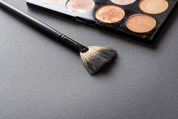 Highlighter palette and a make up brush