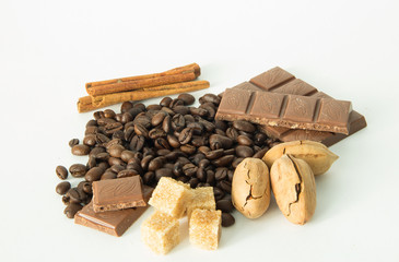 coffee,chocolate,beans,background,spices,anise,cinnamon,sweet,food,brown,nut,dessert,gourmet,almonds,spice,sugar,wooden,tasty,broken,white,cocoa,closeup,delicious,black,orange,isolated,close,snack,mil