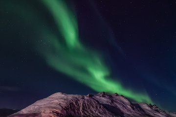 Amazing Aurora Borealis in North Norway (Kvaloya), mountains in the background