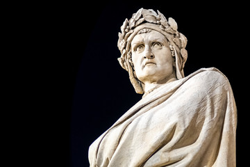 Dante Alighieri statue in Santa Croce square in Florence at night