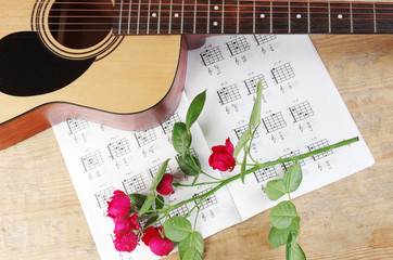 Acoustic guitar and table of chord. Learning to play the guitar