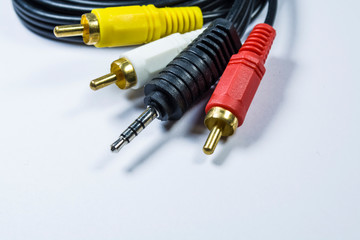 Two hanks of cables with multi-colored plugs a tulip. Black cord. White monophonic background.