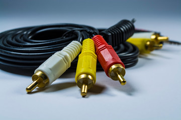 Two hanks of cables with multi-colored plugs a tulip. Black cord. White monophonic background.