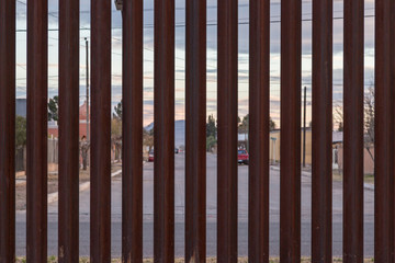 Looking at the border fence between the USA and Mexico, with a town in Mexico visible on the other side