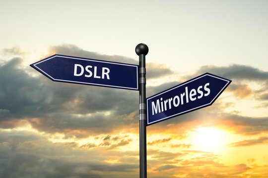 arrow road signs of words dslr and mirrorless on the sunset sky. 3D illustration 