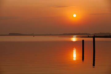 Fototapeta na wymiar majestic sunset with warm water reflections at the Veerse sea in the Netherlands