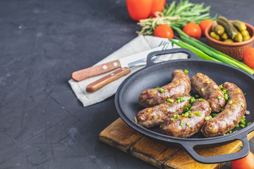 Fried sausage in a frying pan
