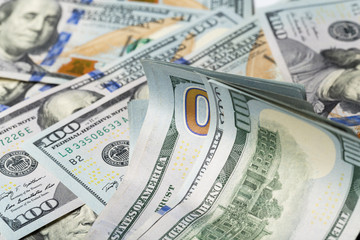 Fototapeta premium American dollars. A stack of hundred dollar bills. Close up