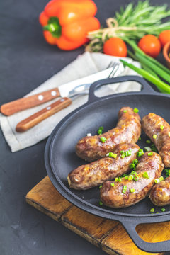 Fried sausage in a frying pan