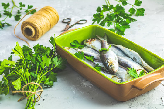 Sardines or baltic herring on green dish