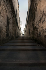 A man walking right up the long stairs