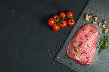 Fresh raw meat beef steak with ingredients for cooking spices