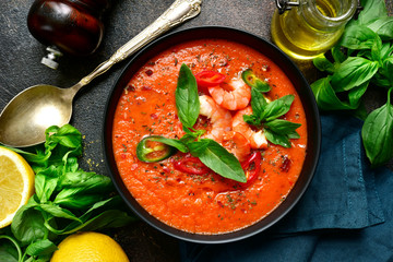 Delicious tomato soup with shrimps. Top view with copy space.