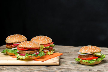 Fresh home made burgers on wooden table