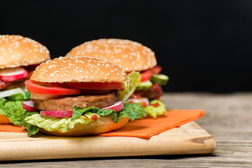 Fresh home made burgers on wooden table