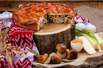 Russian pie with meat and mushrooms. Traditional dish.