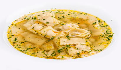 Broth with ravioli on white background