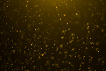 Fototapeta premium Golden bokeh background on light in the dark night