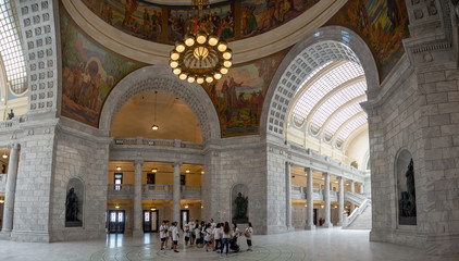 State of Utah Capitol hill complex in Salt Lake City, historic exterior and rotunda dome interior with house, senate and soupreme court chamber, staircase, and paintings, tourist visitors