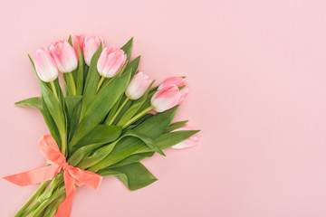 top view of spring tulip bouquet with ribbon isolated on pink