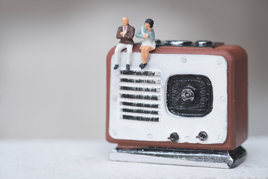 Miniature People Couple Sitting On Radio Retro. Concept Of Good Old Memories