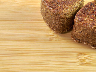 high-quality bread from sprouted wheat heart shape on a cutting board from a noble variety of Chinese bamboo. homebaked bread. healthy food. breakfast. copy space