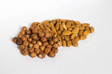 handful of nuts on a white background, almonds and hazelnuts