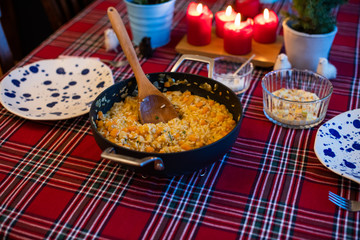 pumpkin risotto served with pan on dining table
