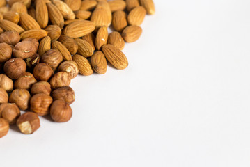 handful of nuts on a white background, almonds and hazelnuts