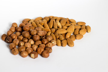 handful of nuts on a white background, almonds and hazelnuts