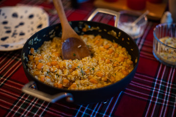 pumpkin risotto served with pan on dining table