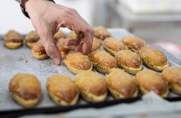 artisan pastry chef placing cake on metal tray