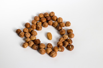  handful of nuts on a white background, almonds and hazelnuts, nest