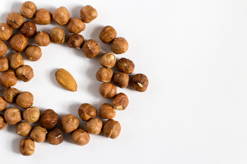  handful of nuts on a white background, almonds and hazelnuts, nest