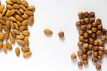  handful of nuts on a white background, almonds and hazelnuts