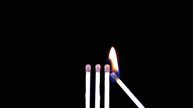 Three Matches are Lit a Flame on a Black Background and then goes out creating a Lot of Smoke