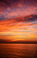 Naklejka na ściany i meble Beautiful cloudscape over the sea after sunset.