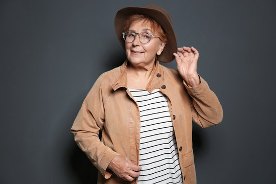 Portrait of elderly woman on grey background