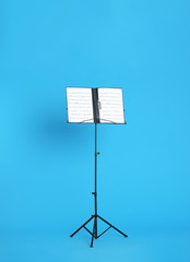 Note stand with music sheets on color background - obrazy, fototapety, plakaty