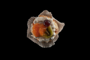 Top view of pastry with cream and fruit topping