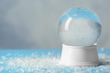 Magical empty snow globe on table. Space for text