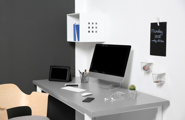 Modern interior of workplace with computer and accessories