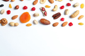 Flat lay composition of different dried fruits and nuts on white background. Space for text